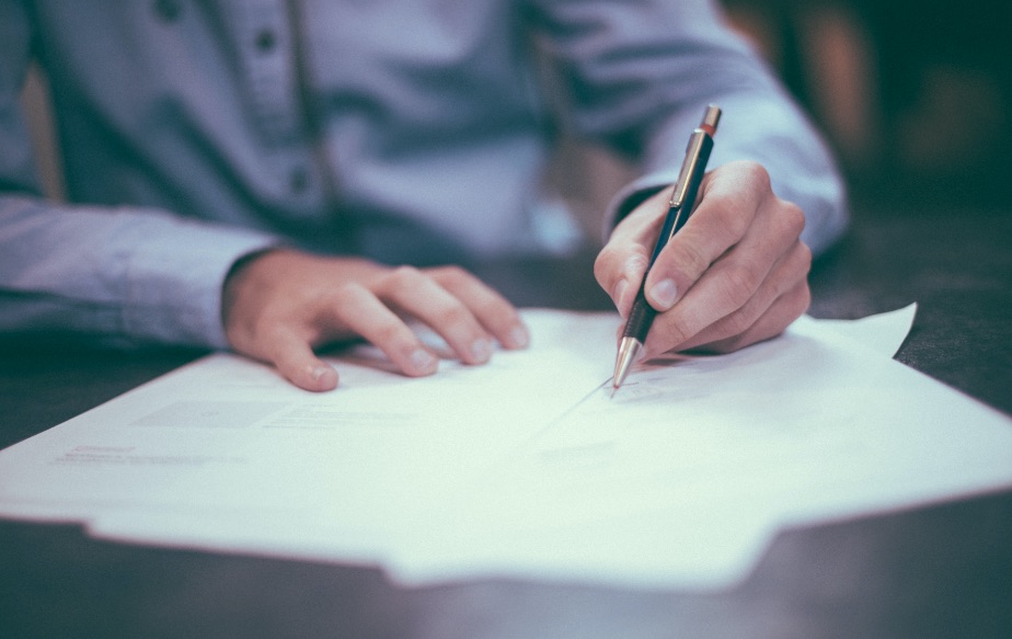 Image of a tax preparation specialist filling out paperwork